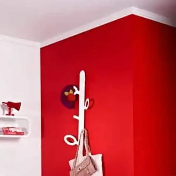 Panel moulding in a modern room corner, white trim against bold red accent wall, Orac C333