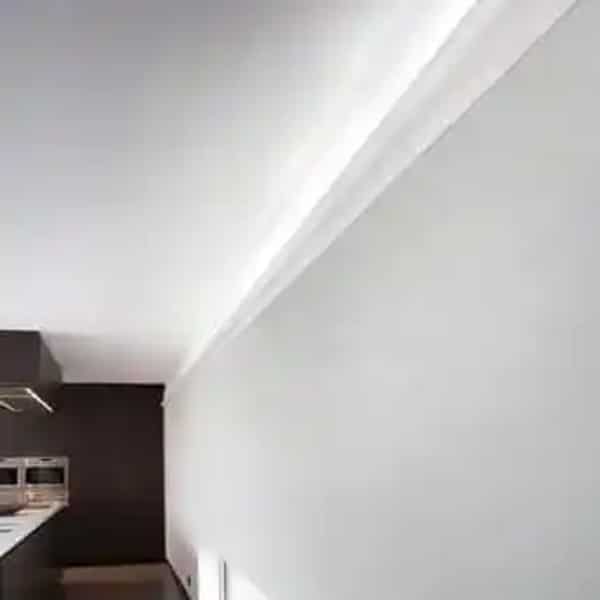 Kitchen corner with Orac C333 coving, white walls and ceiling lighting in a modern interior