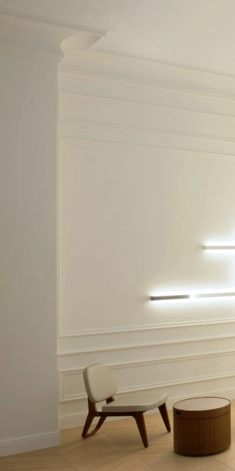 Orac Decor C344 coving in a minimalist white room with chair and round wooden table