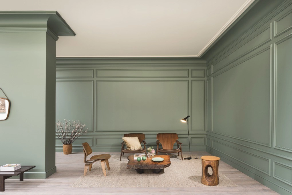 Orac Decor C344 Coving in corner of minimalist living room with sage green panelled walls