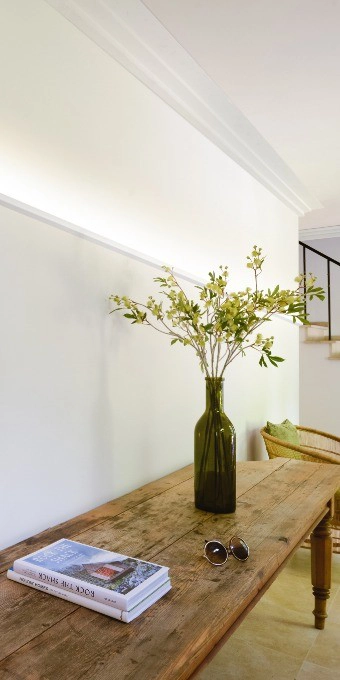 Orac Decor C396 Coving in minimalist interior with wooden table, green vase and wall lights