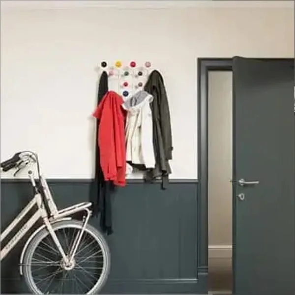 Orac PX175 panel moulding in a modern entryway with coat hooks, jackets, and white bicycle