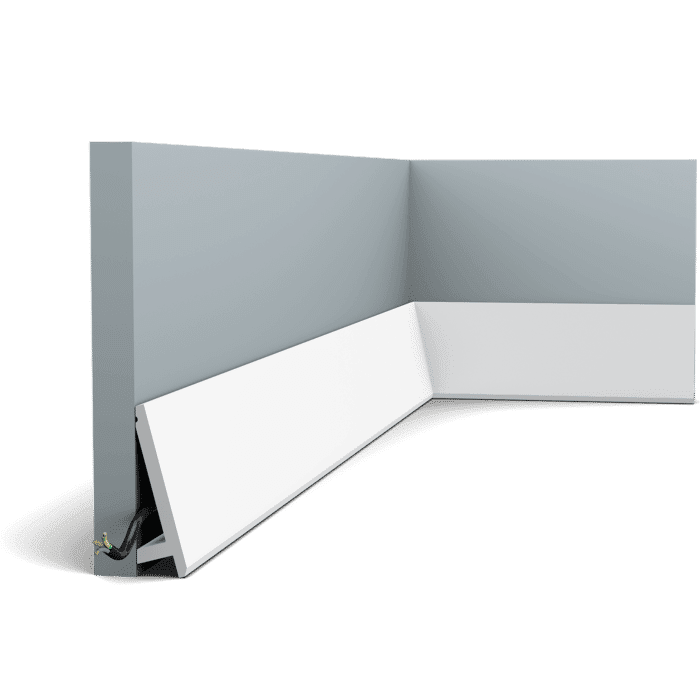 Orac SX179 white skirting trim at the base of a gray wall, installed in a corner