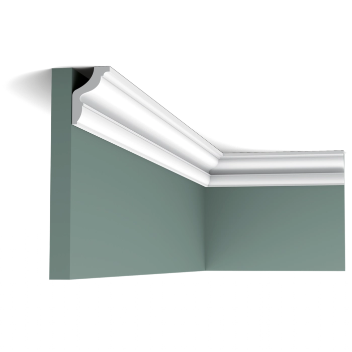 Orac CX148 Coving installed in a room corner against a green wall