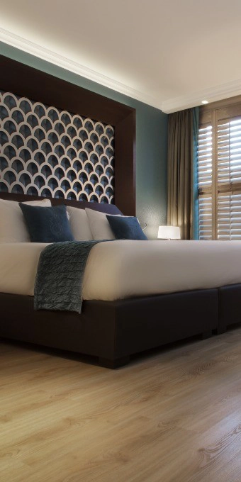 Orac Decor C213 Coving in modern bedroom corner with bed, headboard and wooden flooring