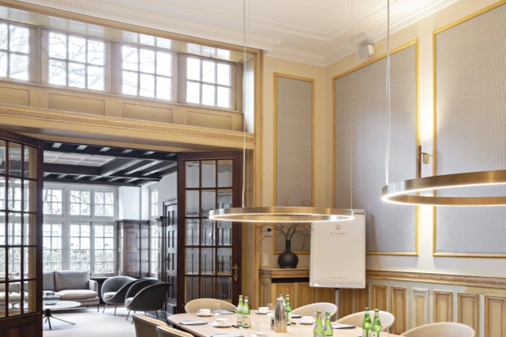 Orac Decor C211 coving in a modern conference room corner with elegant lighting and large windows