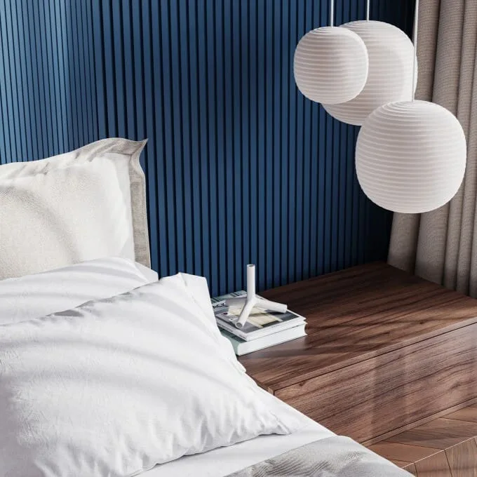 Orac WX204 panel moulding in a modern bedroom corner with white bedding and paper lantern lights