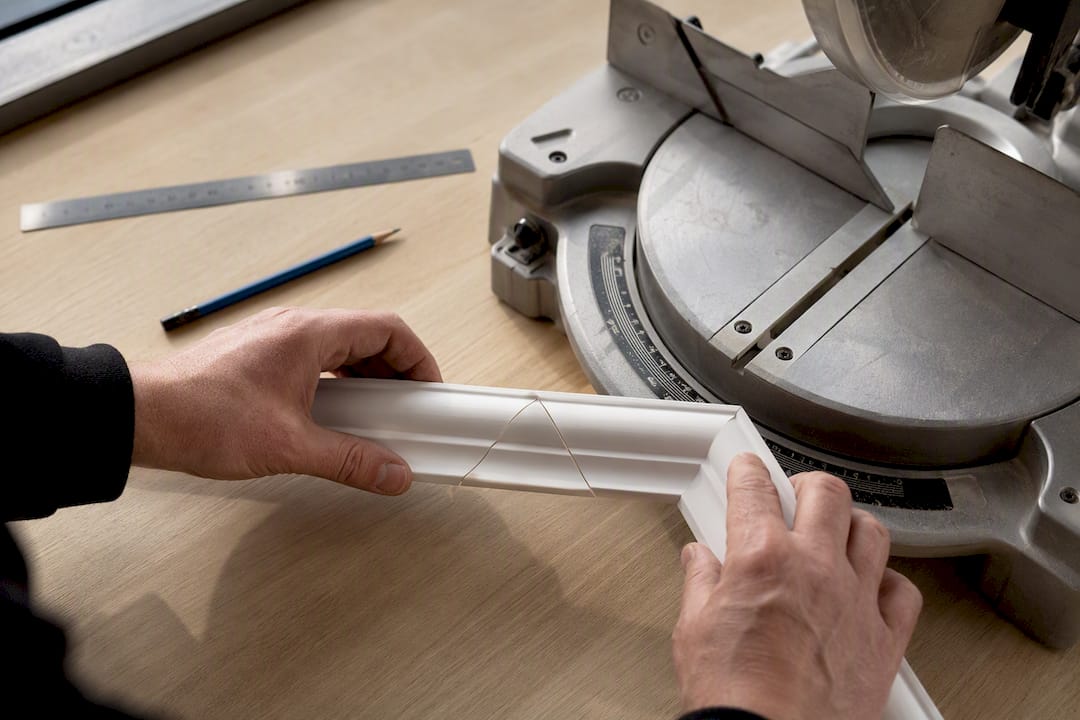 Fitter checking a coving mitre joint