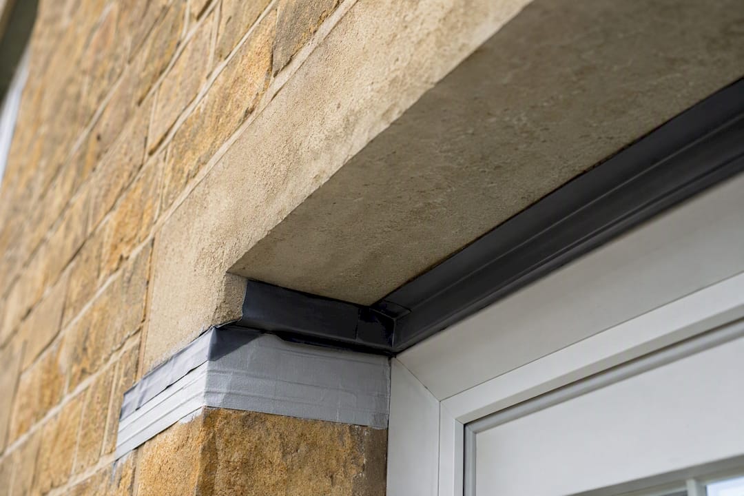 Stone lintel and flashing junction