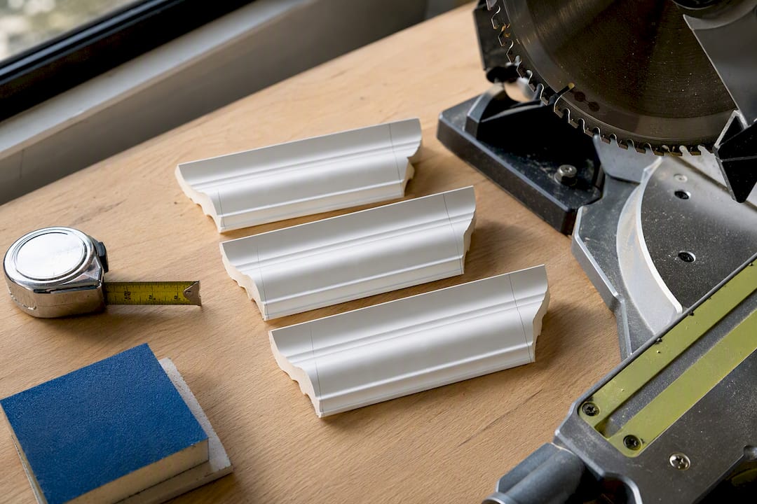 Three coving test cuts beside mitre saw